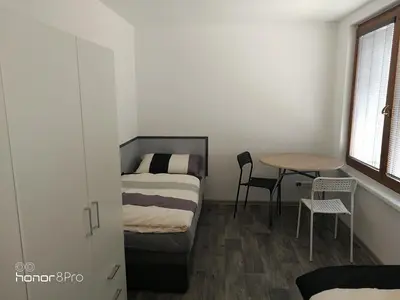 two beds in a attic room with a window at Ubytování Záluží in Kozlovice