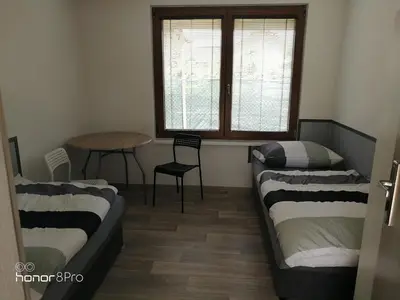 a room with two beds in front of a window at Ubytování Záluží in Kozlovice