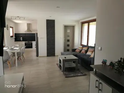 a kitchen with white cabinets and a black counter top at Ubytování Záluží in Kozlovice