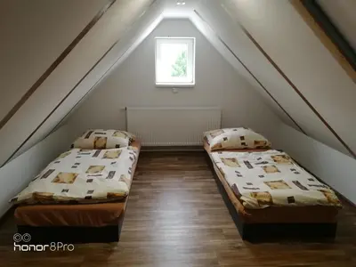 a small bedroom with a bed and a table at Ubytování Záluží in Kozlovice