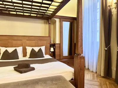 a wooden cabinet with a lamp in a bedroom at Traditional Prague Apartment in Prague