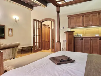 a living room with a table and chairs and a tv at Traditional Prague Apartment in Prague