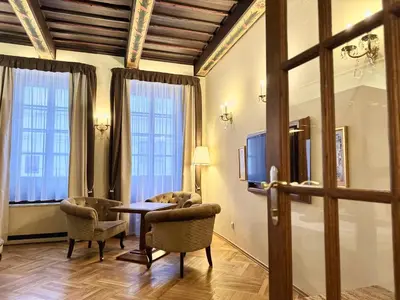 a bedroom with a mirror next to a bed at Traditional Prague Apartment in Prague