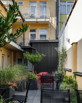 a patio with tables and chairs in front of a building at Seifert Residence in Prague
