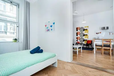 a bedroom with a bed and a dining room at Bright, Spacious Apartment in the Historic Centre in Prague