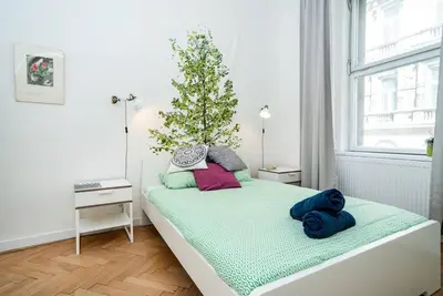 a small bedroom with a christmas tree on a bed at Bright, Spacious Apartment in the Historic Centre in Prague