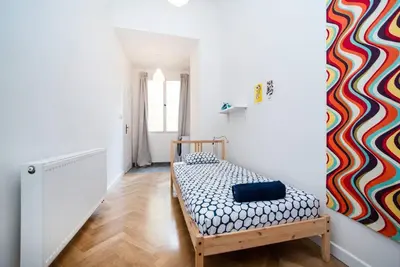 a room with a bed with a colorful wall at Bright, Spacious Apartment in the Historic Centre in Prague