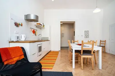 a kitchen and dining room with a table and chairs at Bright, Spacious Apartment in the Historic Centre in Prague
