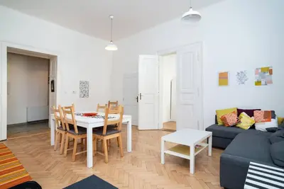 a living room with a table and chairs and a couch at Bright, Spacious Apartment in the Historic Centre in Prague