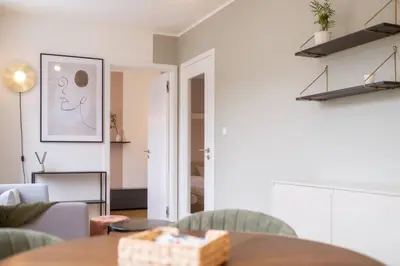 a living room with a table and chairs at Charming apartment for two in uptown in Prague