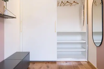an empty refrigerator in a room with a mirror at Charming apartment for two in uptown in Prague