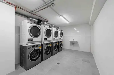 a laundry room with three washing machines in it at Charming apartment for two in uptown in Prague