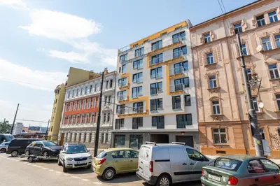 a parking lot with cars parked in front of a building at One bedroom penthouse apartment # 82 in the brand new building close to the city center with free parking in Prague