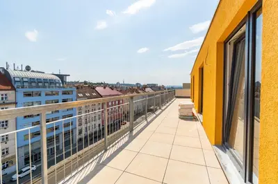 a balcony with a view of a city at One bedroom penthouse apartment # 82 in the brand new building close to the city center with free parking in Prague