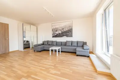a living room with a couch and a table at One bedroom penthouse apartment # 82 in the brand new building close to the city center with free parking in Prague