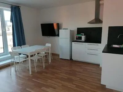a kitchen with a table and chairs in a room at One bedroom penthouse apartment # 82 in the brand new building close to the city center with free parking in Prague