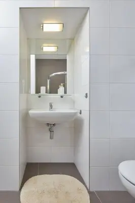a white bathroom with a sink and a toilet at Gentle and cozy apartment right at the Center Prague in Prague