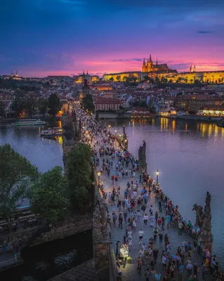 a group of people walking on a bridge over a river at Gentle and cozy apartment right at the Center Prague in Prague