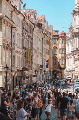 a large crowd of people walking down a street at Gentle and cozy apartment right at the Center Prague in Prague