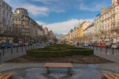 a bench in the middle of a city street at Gentle and cozy apartment right at the Center Prague in Prague
