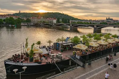 a boat on a river with a restaurant on it at Gentle and cozy apartment right at the Center Prague in Prague