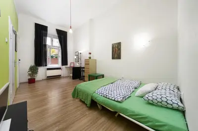 a bedroom with a bed with a green comforter at LIKE AT HOME IN CENTER OF PRAGUE in Prague