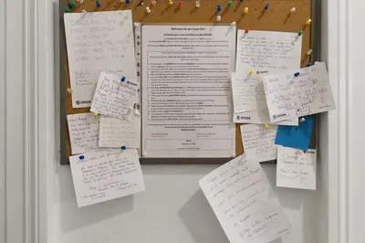 a bunch of papers hanging on a refrigerator at LIKE AT HOME IN CENTER OF PRAGUE in Prague