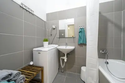 a bathroom with a sink and a toilet and a mirror at LIKE AT HOME IN CENTER OF PRAGUE in Prague