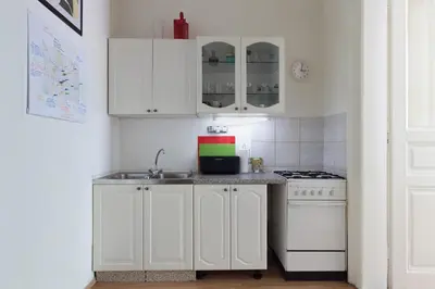 a kitchen with white cabinets and a sink and a stove at LIKE AT HOME IN CENTER OF PRAGUE in Prague