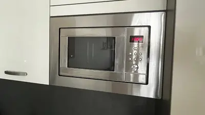 a stainless steel microwave oven in a kitchen at Residence Garden Tower - 8 min do centra, garaz in Prague