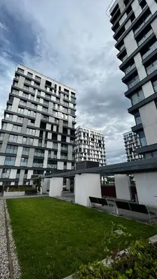 two tall buildings with a grass field in front of them at Residence Garden Tower - 8 min do centra, garaz in Prague