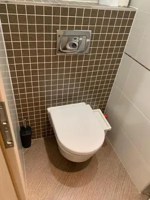 a bathroom with a toilet in a tiled wall at Residence Garden Tower - 8 min do centra, garaz in Prague