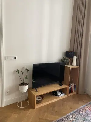 a flat screen tv on a wooden stand in a living room at Luxury apartment in the centre in Prague