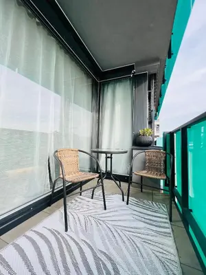 a balcony with two chairs and a table and a window at White Pearl Studio with parking in Holešovice in Prague