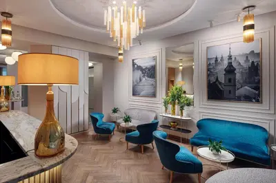 a living room with blue chairs and a table at Allure Hotel & Residence Prague in Prague