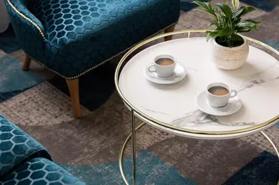 two cups of coffee on a table with a potted plant at Allure Hotel & Residence Prague in Prague