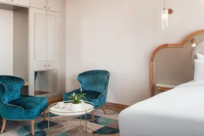 a hotel room with two chairs and a bed at Allure Hotel & Residence Prague in Prague