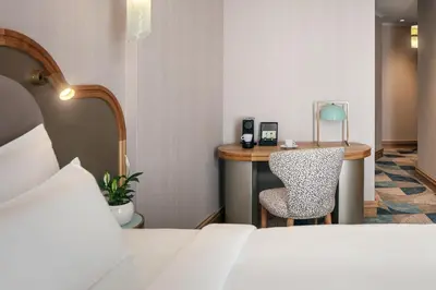 a hotel room with a bed and a desk with a chair at Allure Hotel & Residence Prague in Prague