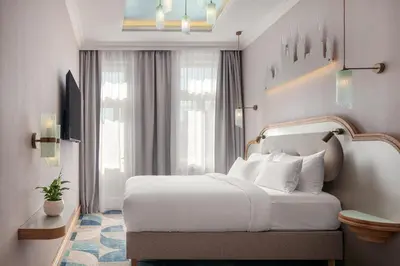 a bedroom with a white bed and a window at Allure Hotel & Residence Prague in Prague