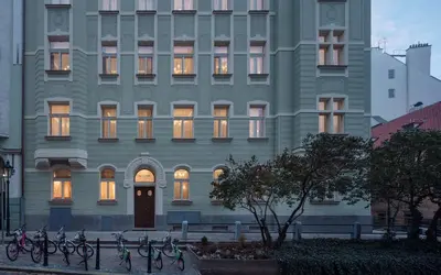 a large building with bicycles parked in front of it at Allure Hotel & Residence Prague in Prague