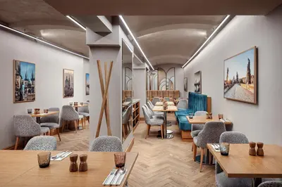 a restaurant with wooden tables and chairs and tables and chairs at Allure Hotel & Residence Prague in Prague