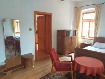 a room with a bed and a table and a chair at Apartmán Chrpa in Snědovice