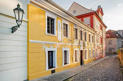 a row of yellow buildings on a street at Spa Beerland Chateaux – U Zlaté Hrušky / At Golden pear in Prague