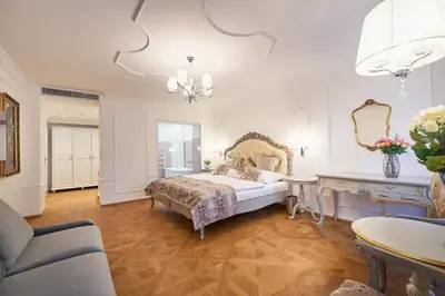 a bedroom with a large bed and a table at Spa Beerland Chateaux – U Zlaté Hrušky / At Golden pear in Prague