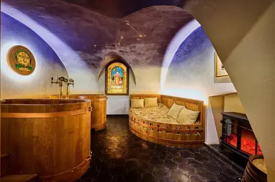 a room with a tub and a bed and a window at Spa Beerland Chateaux – U Zlaté Hrušky / At Golden pear in Prague