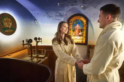 a man and a woman holding hands in a bar at Spa Beerland Chateaux – U Zlaté Hrušky / At Golden pear in Prague