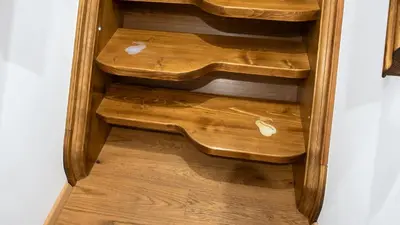 a wooden bookcase with wooden steps in a room at Spa Beerland Chateaux – U Zlaté Hrušky / At Golden pear in Prague