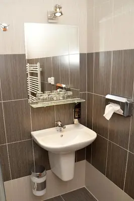 a bathroom with a sink and a mirror at Hotel Na Statku in Nepřevázka