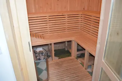 an empty sauna with wooden floors and wooden shelves at Hotel Na Statku in Nepřevázka