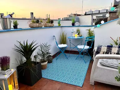 a balcony with potted plants and a table at Duplex 2 with quiet terrace on Wenceslas Square in Prague